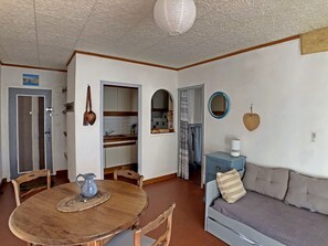 Cozy living space with a dining area, kitchenette, and comfortable sofa.