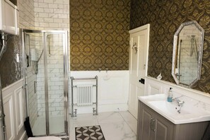 A bathroom with a shower, a toilet, a sink, and a mirror. - Beach Views, Elegant & Modernised 5BD Period Home (Tramore)