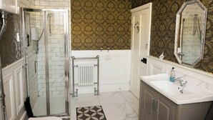 A bathroom with a shower, a toilet, a sink, and a mirror. - Beach Views, Elegant & Modernised 5BD Period Home (Tramore)