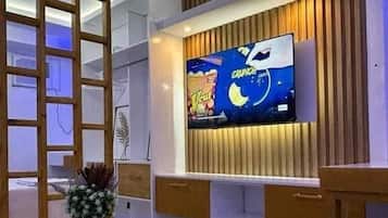 Classic Studio, Non Smoking, City View | Living area | 50-inch Smart TV with digital channels