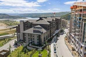 A multi-story building with a modern architectural design, featuring a mix of balconies and large windows.