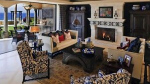 Un salon spacieux avec une cheminée, un canapé et une table basse.