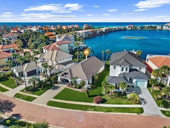 A residential area with houses, a marina, and a clear view of the ocean.
