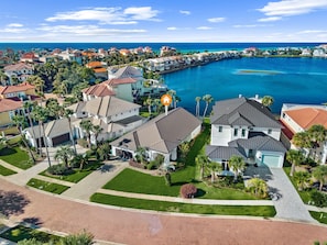 A residential area with houses, a marina, and a clear view of the ocean.