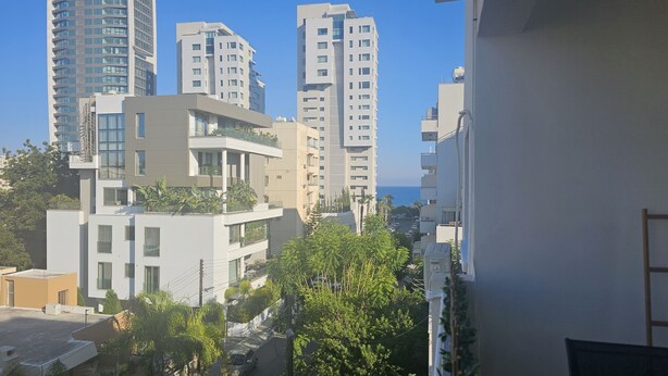 A modern urban residential area with high-rise buildings, a clear sky, and some greenery. - 150 LIM -stay Limdream Apartment (Limassol)