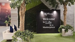 An indoor garden area with a welcome sign, artificial trees, and a sofa with cushions. - Cozy studio with Pool and fitness room in enjoyable Cebu City (Cebu City)