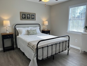 A bedroom with a bed, two bedside tables, a window, and a ceiling fan. - Spacious 4Bed/2Bath:Newly Refurbished: 2 Floors w/2 Living Rooms: 15 Min to GOLF (Augusta)