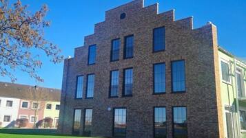 A multi-story building with a brick facade and large windows.