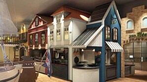 A model of a town with a central building featuring a sloped roof and a sign that reads "Sieg."