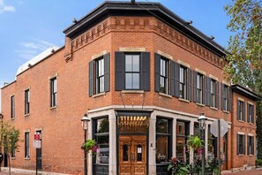 Stylish corner building with a traditional urban facade and ornate entrance.