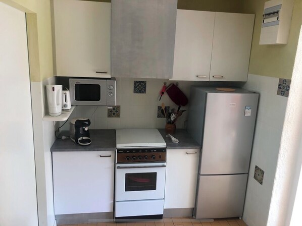 Prepare meals in this compact kitchen with an oven, microwave, and coffee maker.