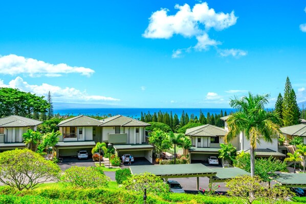 A coastal resort with multiple villas, each with a private garage and a view of the ocean.