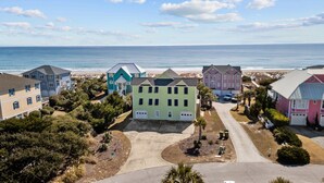 A coastal residential area with houses, a beach, and a clear sky. - Bright, spacious oceanfront duplex with pool access (Emerald Isle)
