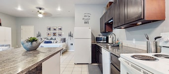 Studio unit with full kitchen, W/D, fireplace, & patio area