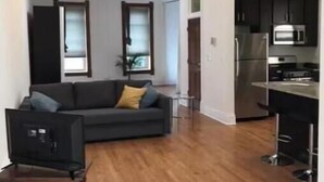 A modern apartment with a living room, kitchenette, and a dining area. - Spacious loft in the heart of West Town, Noble Square Chicago (Chicago)