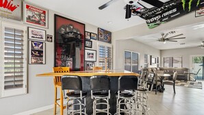 A spacious living area with a large sofa, a dining table with chairs, and a kitchen area. - Amazing Gilbert Retreat (Gilbert)