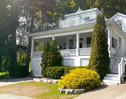 Heritage style cottage with lake view, perfect porch for family gatherings.
