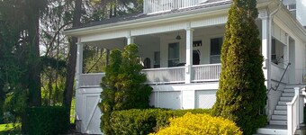 Heritage style cottage with lake view, perfect porch for family gatherings.