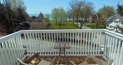Heritage style cottage with lake view, perfect porch for family gatherings.