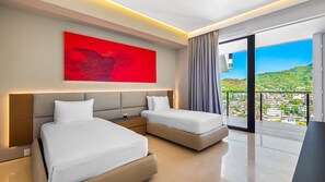 A modern hotel room with two beds, a red abstract painting, and a balcony with a city view.