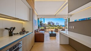 A modern kitchen with a view of the city and ocean. - SoHo PV - 411 (Puerto Vallarta)