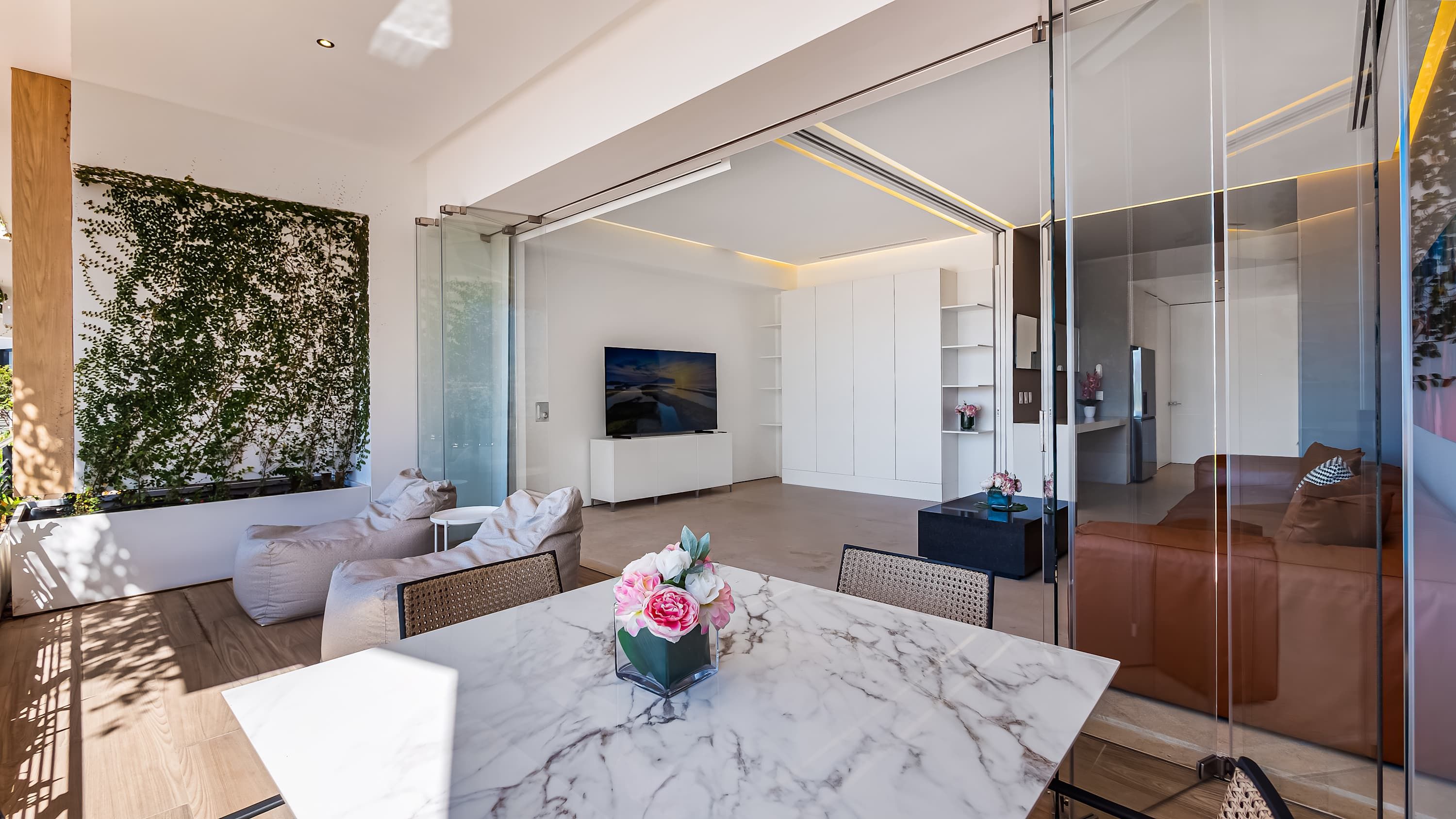 A modern living room with a marble table, a sofa, and a TV.