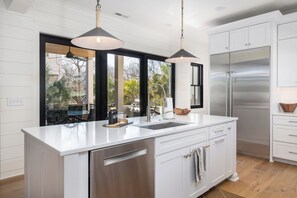 Fridge, dishwasher, coffee/tea maker, cookware/dishes/utensils