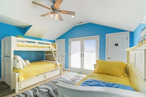 A bedroom with a bunk bed, a ceiling fan, and a window with blinds. - Bethany Beach Waterfront Oasis! (South Bethany)