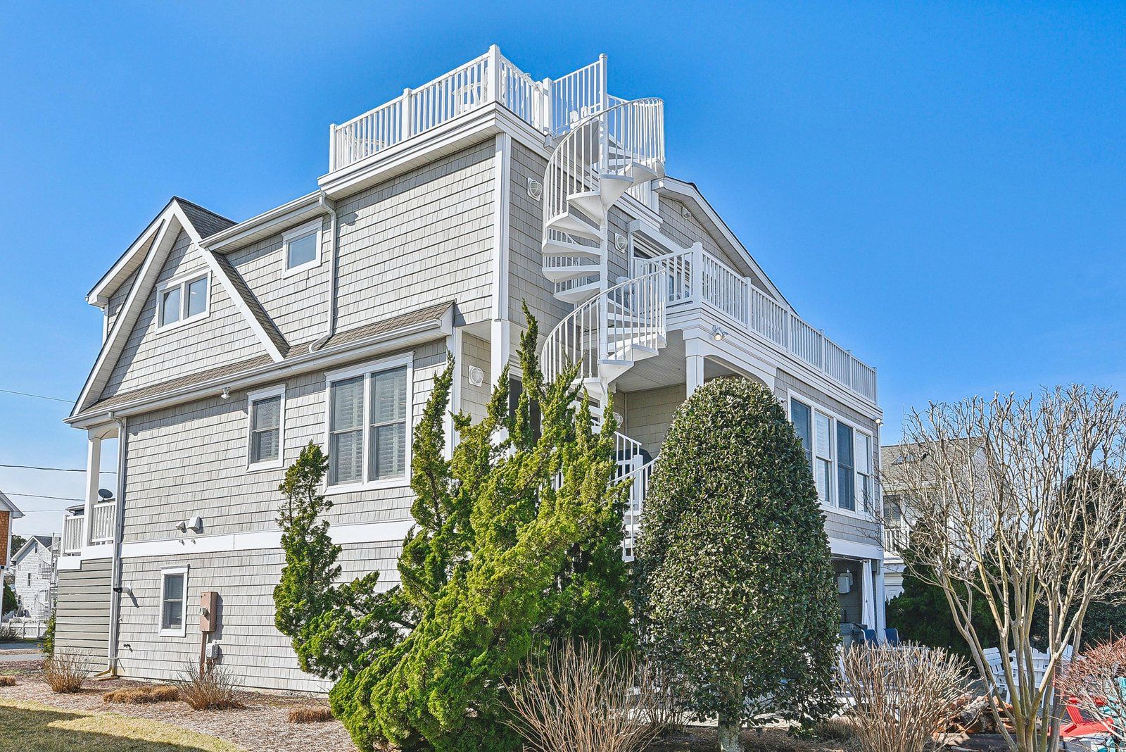 A two-story house with a prominent front staircase and a balcony.