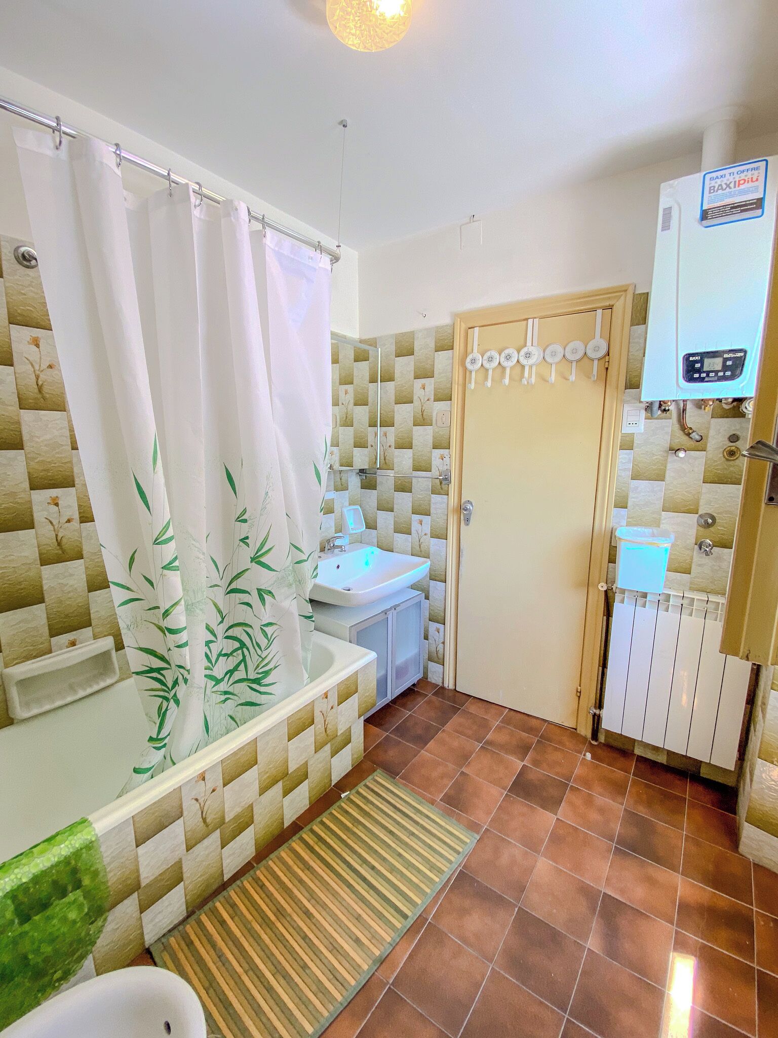 A bathroom with a shower, sink, and toilet.