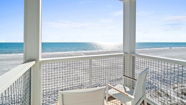 A covered outdoor seating area with a view of the beach and ocean. - Wavy Daze: New Construction, Private Pool, Pet Friendly, Gorgeous Beach Views (St Joe Beach)