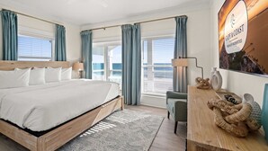 A hotel room with a large bed, a desk, and a view of the ocean. - Wavy Daze: New Construction, Private Pool, Pet Friendly, Gorgeous Beach Views (St Joe Beach)