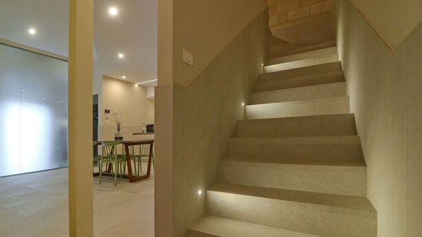 A staircase with a modern design, leading to an upper floor.