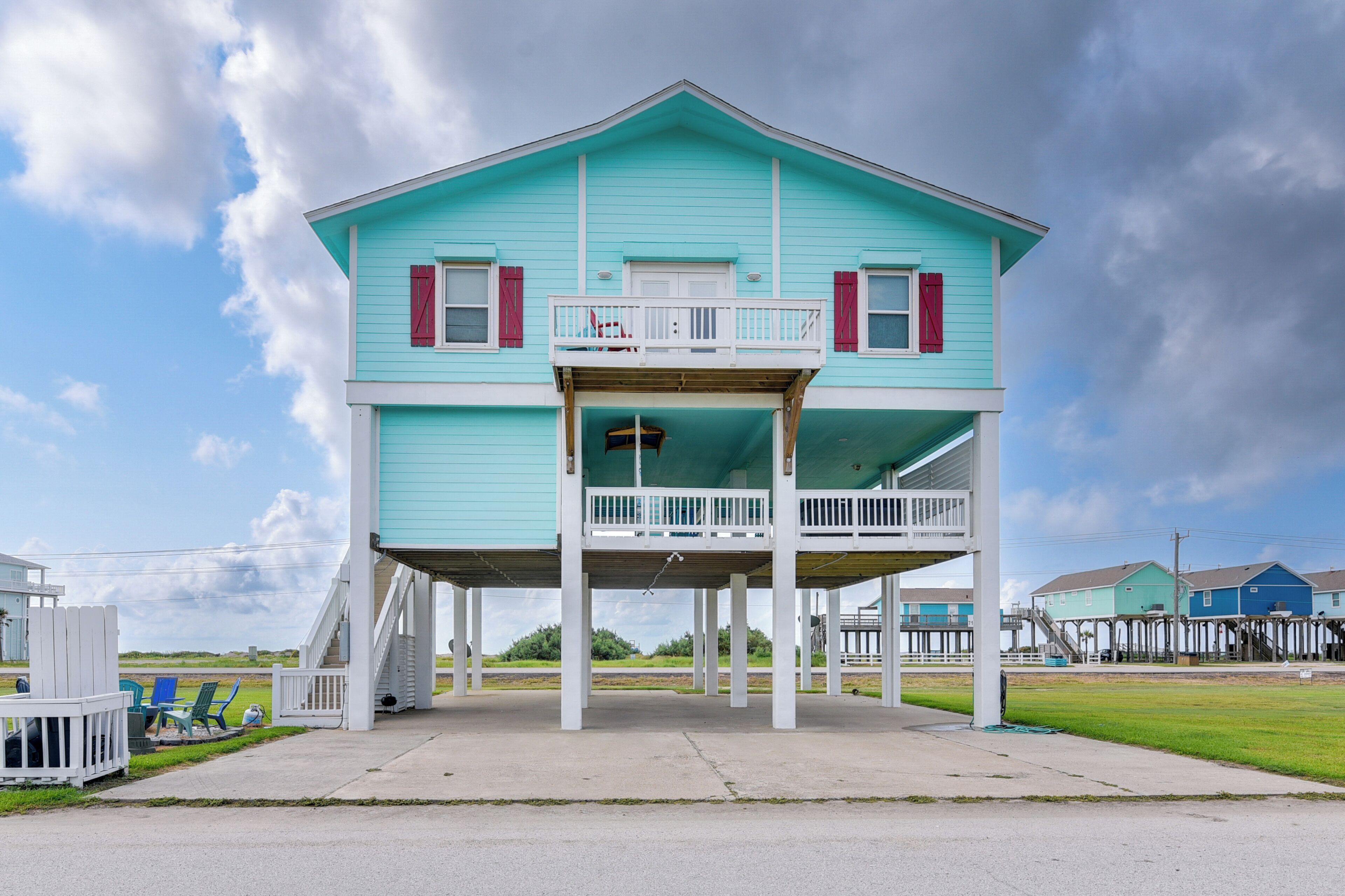A two-story house with a balcony, a porch, and a small deck area.