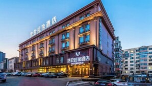 A multi-story hotel with a classic architectural design, featuring a prominent entrance and multiple balconies. - Diyu Mansion Hotel (Harbin Central Street) (Harbin)