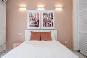 Relax in a spacious room with a large bed, framed city views, and a cozy headboard.