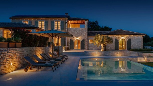 A large stone house with a swimming pool, outdoor seating, and a well-lit entrance. - Villa Olive View – Your Exclusive Retreat (Vabriga)