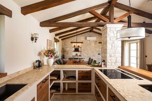 Enjoy cooking in this kitchen with a central island, cabinetry, and large window.