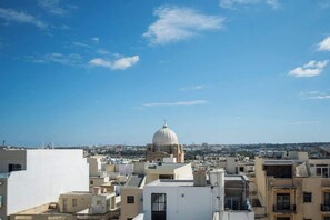 A cityscape with a prominent dome structure, likely a historical or religious building, surrounded by modern buildings.