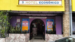 The entrance to Hotel Economico with a sign indicating a weekly rate of $3,070 for one person. - HOTEL ECONOMICO (Tijuana)