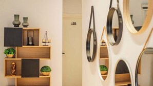 A modern interior with wooden shelves, decorative items, and a door labeled '01'.