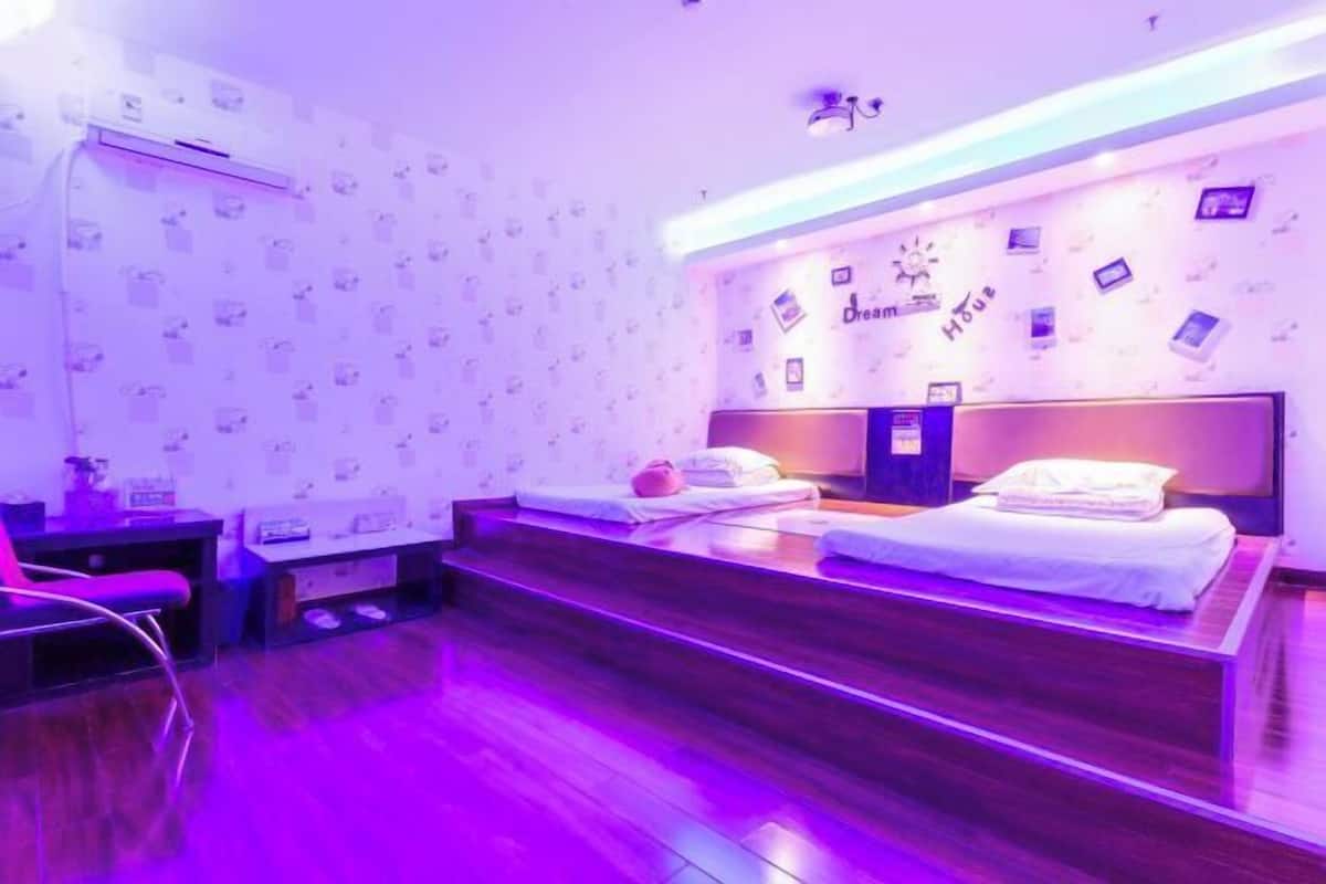A room with a bed, a desk, and a chair.