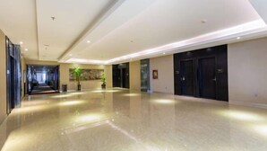 A spacious, well-lit hallway with a polished floor, leading to a set of dark-colored doors. - Lemon Hotel (Karamay Dushanzi) (Karamay)