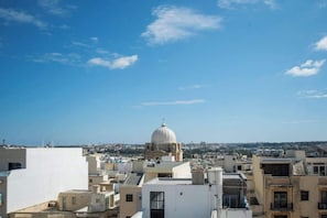 A cityscape with a prominent dome structure, likely a historical or religious building, surrounded by modern buildings.