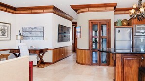 A kitchen with wooden cabinetry, a built-in oven, and a refrigerator.