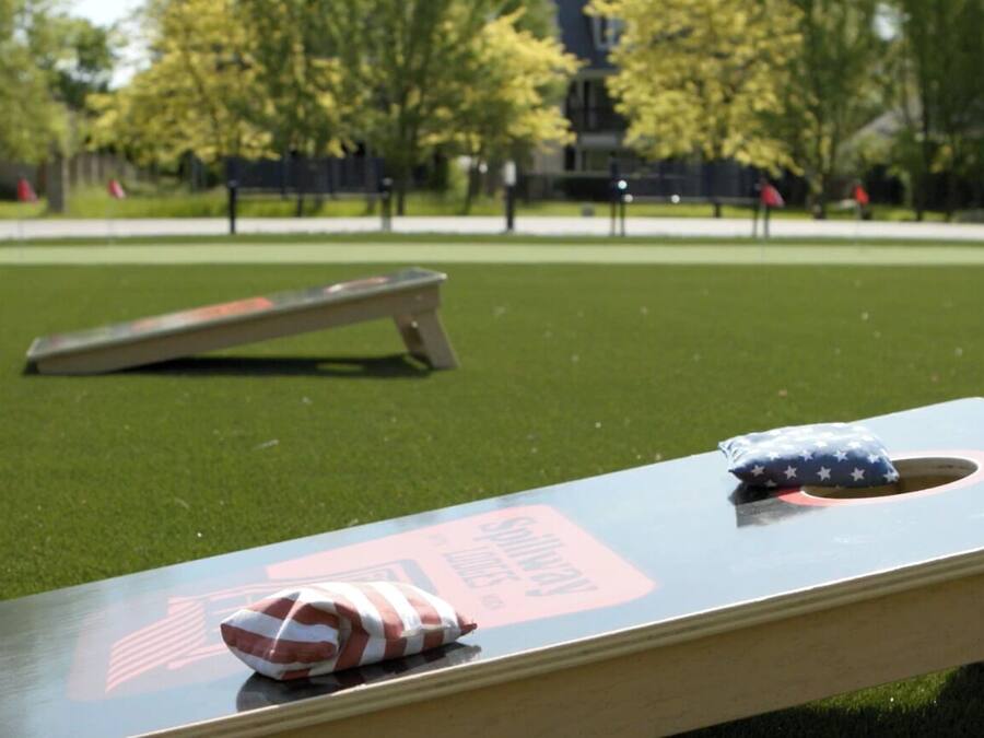 A park with a metal table and a flag on it.