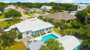 Zona residencial con casas, piscina y un amplio césped.