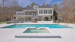 A large two-story house with a swimming pool in the foreground. - Serene Farms Hot Tub Pool Sunroom on 7 Acres (Hiram)
