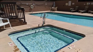 A rectangular pool with a tiled edge and a shallow end, surrounded by a concrete deck. - La Plata Views | In-Town | Pool | Hot Tub (Durango)