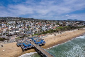 A coastal town with a beach, a pier, and residential buildings. - Splendid Beach Condo (San Clemente)